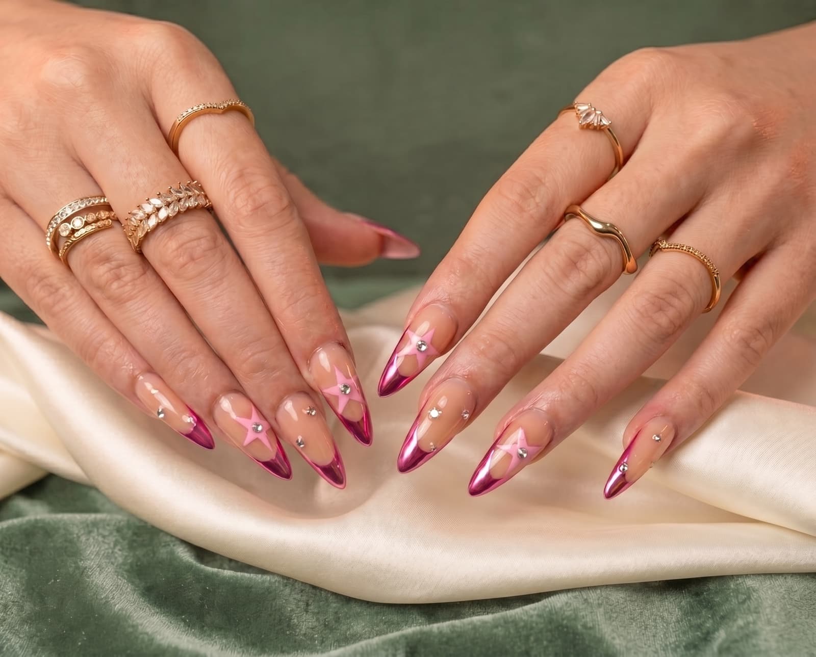 Magenta chrome nails with pink stars and gold rings